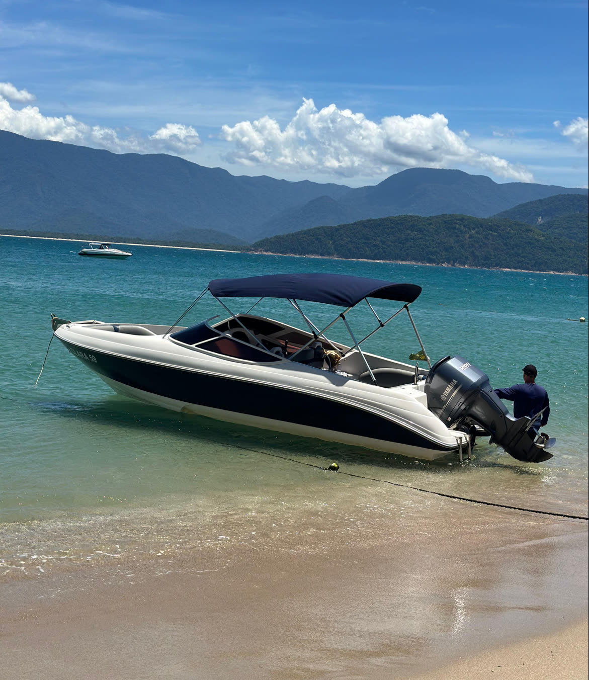 Lanchas ancoradas em água verde-esmeralda em Ubatuba, vistas de drone